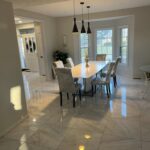 Dining area with a large table and modern lighting fixtures