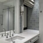 Bathroom vanity with a marble countertop and a large mirror